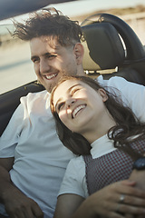 Image showing Roadtrip, travel and couple in a car on the road together, taking a drive. Love, dating and happy couple in motor vehicle hugging, laughing and smile on their face on holiday, vacation and adventure