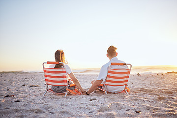 Image showing Love, couple and holding hands while on beach with sunset, ocean and relax while on sand, holiday and vacation. Romance, man and woman have fun together, .and enjoy seaside getaway for anniversary.