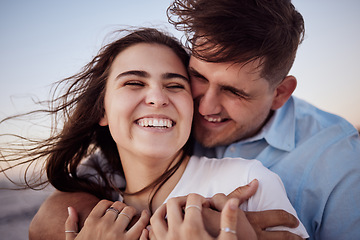 Image showing Couple, happy and sunset together for honeymoon with hands for hug at beach in zoom. Man and woman with smile on face for romance, happiness and love on vacation, travel or holiday by sea in Hawaii