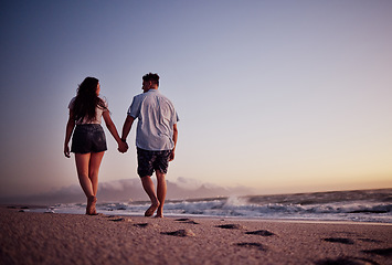 Image showing Couple, holding hands and love for beach walk together in romantic summer sunset in the outdoors. Hand hold of man and woman walking on a beautiful ocean coast in romance for vacation in Costa Rica