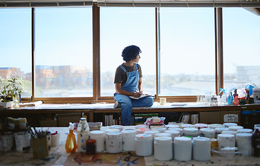 Image showing Idea, creative and woman thinking while drawing with inspiration at a window in a studio. Indian artist, designer or creativity student with goal and vision for design job on paper at a workshop