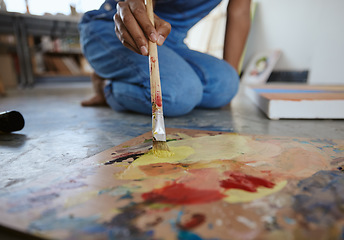 Image showing Artist woman, painting and paint brush on art studio floor being creative and working with watercolor for artwork project. Talented, skill and canvas closeup with hand of a female painter in workshop