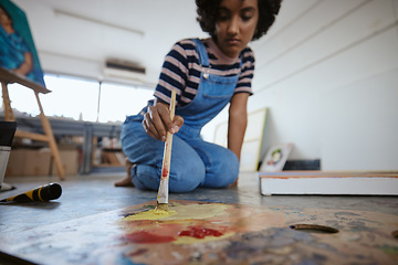 Image showing Woman artist, painting and canvas on floor in art studio for creative exhibition, design academy and students home workshop, school or gallery. Designer, watercolor painter and brush stroke project