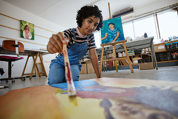 Image showing Art, creative and painter painting with watercolor and brush on a canvas at a table in a work studio. Indian design artist, woman or creativity student working as a designer with paint in a workshop