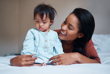 Image showing Love, mother and down syndrome baby in bedroom together to relax and bond in Puerto Rico house. Care, love and support of mom embracing child with mental disability on bed in happy family home.