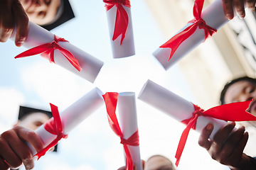 Image showing Graduation circle, success and students certificate, diploma or degree in hands huddle from below. Low angle, education and university people, friends or graduates celebrate after studying in academy