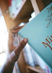 Image showing Bookshelf, library and books in student hand for learning, scholarship education and knowledge. Person with print literature for research, search for inspiration and studying at university or college