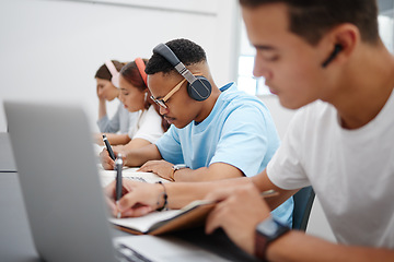 Image showing Student at university study, writing and research for a exam or project with headphones for podcast or music. College, school or education black man learning, scholarship and studying in campus hall