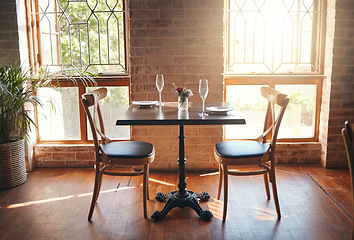 Image showing Empty room, glasses and table at a restaurant for a romantic date, celebration or luxury dinner. Wineglass for champagne, wine or alcohol beverage for a banquet, romance meal or elegant event.