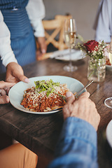 Image showing Food, restaurant and hands with a couple and waitress serving a pasta in a fine dining establishment. Date, romance and together with a senior man and woman enjoying eating on their anniversary