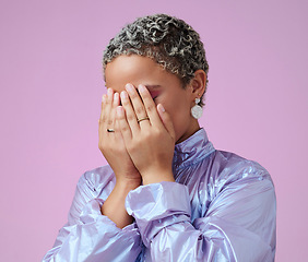 Image showing Hands, shy and hiding black woman in studio, embarrassed by trendy fashion and edgy makeup. Beauty, hand and face covering by cute lady hide after glamour and makeover against pink background mockup