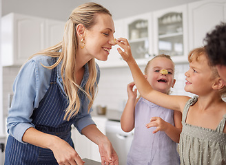 Image showing Family baking and mother teaching children to bake cake in the kitchen of their home. Happy girl kids and woman play, cooking and laugh together while learning about food and being playful in home