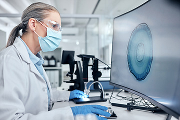 Image showing Scientist with computer screen, digital microscope and ppe analysis of bacteria for virus test, vaccine or research innovation and technology. Medical virus expert woman with pc monitor in laboratory