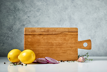 Image showing still life with wooden cutting board and spices