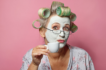 Image showing funny senior woman with cosmetic face mask