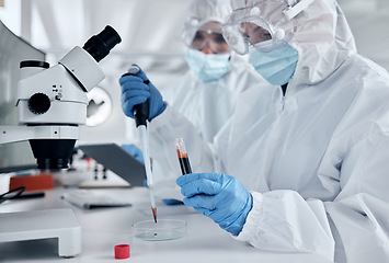 Image showing Covid, blood and DNA with a science woman working in a lab for research, innovation and healthcare. Analytics, medical and breakthrough with a female scientist at work in a futuristic laboratory