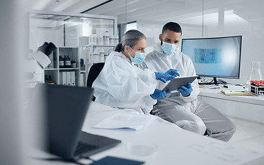 Image showing Covid research, tablet and science with a man and woman scientist working in a lab for innovation and healthcare. Medical, internet and analytics with a medicine team at work in a laboratory
