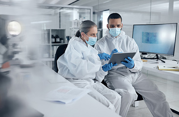 Image showing Research, covid and tablet with doctors reading information for work discussion. Medical, team and PPE for safety, health and wellness while doing research on coronavirus together in lab at hospital