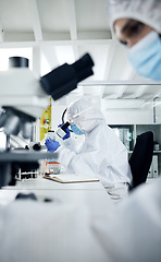 Image showing Science, laboratory and scientist doing covid research on dna, rna and medical development with a microscope. Scientists in hazmat suits, face mask and safety gloves busy working experiment testing