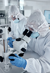 Image showing Research, covid hazmat or dengue scientist work in a medical staff lab in a hospital or clinic. Science, microscope and working laboratory workers with technology for disease analysis and innovation