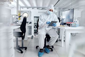 Image showing Covid, ppe and tablet with scientist in research laboratory for corona virus innovation, data management software and online results. Biotechnology expert digital analysis of healthcare medical test