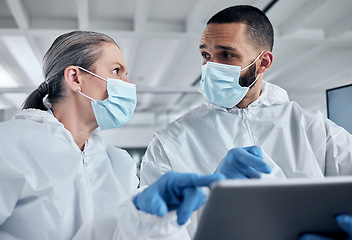 Image showing Scientist team, covid research and tablet with doctors discussing medical information, analysis and teamwork in lab. Medical man and woman using technology and PPE for safety, health and wellness