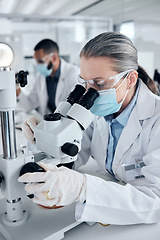 Image showing Innovation, covid and scientist woman with microscope and ppe for science research development or test in laboratory. Expert worker with biotechnology analysis studying sample for medical healthcare