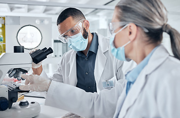 Image showing Science, teamwork and research with a lab partner using microscope. Man and woman scientist doing lab test, biotechnology and medical analytics in laboratory. Working with medicine in healthcare team