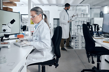 Image showing Laboratory woman, microscope or computer typing in cancer research, medical healthcare innovation or insurance medicine. Mature DNA scientist or science ideas with man in teamwork collaboration study