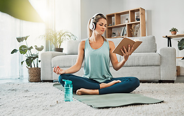 Image showing Meditation yoga, calm music and woman reading a book while listening to podcast on the living room floor of a house. Girl training her mind with a book for knowledge, relax and peace in the lounge