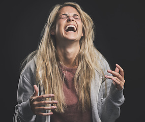 Image showing Mental health, crazy and bipolar woman laughing or shouting in dark studio for psychology, depression or identity problem. Drugs addiction, schizophrenia or horror girl psychedelic after abuse