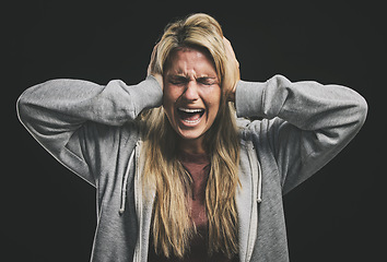Image showing Anxiety, bipolar woman crying, frustrated or crazy on a dark studio for psychology and mental health mock up. Trauma, schizophrenia or depressed girl shout with depression, fear and mental illness
