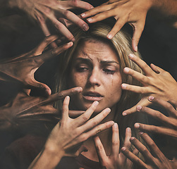 Image showing Many hands, face and abuse with a woman victim feeling fear, alone or crying in studio on a dark background. Sad, pain and violence with a scared female suffering with stress or social anxiety