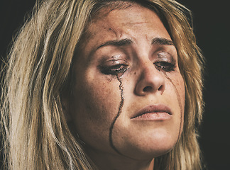 Image showing Sad, depression and woman crying with makeup smudge on face from tears with studio wall closeup. Depressed, hopeless and unhappy girl with mental health problem in distress with messy mascara.