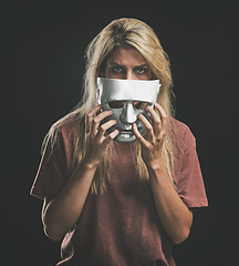 Image showing Sad portrait and woman with bipolar mask to hide depression struggle with mockup in studio. Depressed girl hiding identity, emotions and mental health disorder with theatre face disguise.