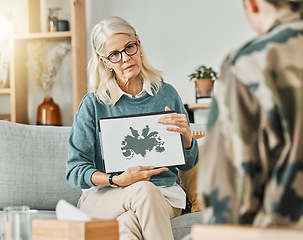 Image showing Therapy, evaluation and psychologist talking to a patient about an inkblot picture in an office together. Mature therapist consulting with a client about mental health and counseling with a test