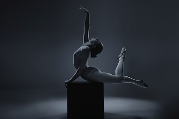 Image showing Ballet, dance and woman ballerina in art pose for a theatre or stage performance with a dark background. Young dancer, creative production and artistic mockup, monochrome and rehearsal for show.