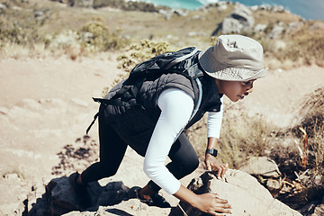 Image showing Woman, hiking and rock on mountain for climbing, workout or fitness. Girl, health and exercise for training, sport and wellness on adventure in nature in summer on hill, hiker and stone in Australia