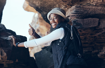 Image showing Woman, thumbs up and hiking success in mountains cave, countryside environment or remote Namibia landscape. Portrait, smile and motivation fitness hiker in nature exercise, training or health workout