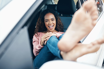 Image showing Portrait of woman with feet out window of car, sitting with smile on face. Travel, freedom and weekend holiday on a road for adventure. Young girl, barefoot and happy on roadtrip for summer vacation
