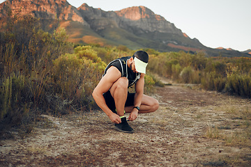 Image showing Man, hiking and shoelace on mountain for workout, fitness and run. Shoes, sneakers and male training for sports and health on adventure in summer with wellness, nature and running in Australia