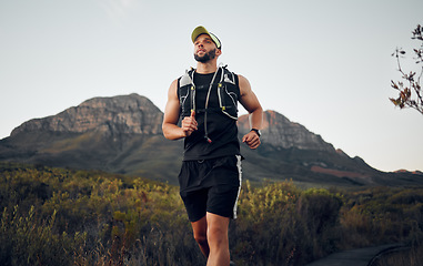 Image showing Fitness man running exercises alone in nature outdoor on a sunny day. Muscular male runner with sportswear run with speed, endurance and cardio with strength training, hike or workout during sunset