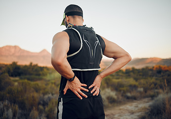 Image showing Muscle, injury and back pain after a workout or running outdoor. Man holding lower back muscles in pain after exercise, hike and run. Accident, hurt and physical strain for backache during exercise