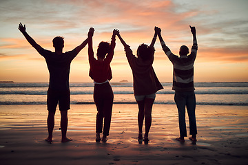 Image showing Beach, celebration and friends silhouette, sunset horizon and ocean for night, youth and adventure lifestyle. Freedom, group people shadow holding hands in dark sea with orange background mock up