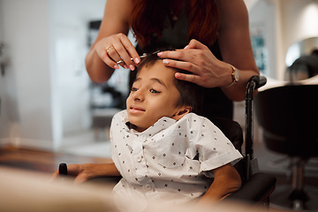 Image showing Hairdresser, disability and wheelchair of child with cerebral palsy getting salon hair trim. Young kid with special needs in Mexico getting professional haircut with scissors from hairstylist woman