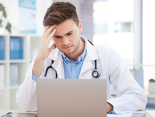 Image showing Doctor, computer working and work headache of a man healthcare worker struggling with tech. Medical stress, anxiety and burnout of a hospital or clinic employee using technology with a web glitch