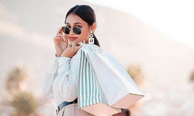 Image showing Woman, classy fashion and shopping with bags in luxury designer clothes for wealthy lifestyle. Portrait of a rich female shopaholic or shopper with glasses in travel and retail spree in Puerto Rico