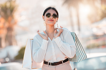 Image showing Shopping, wealth and woman on smile for fashion discount, promotion and sales deal in retail market. Freedom, smile and customer or latino female walking with bags of clothes outdoor in Paris, France