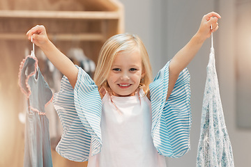 Image showing Girl child, choice or change clothes in fashion brand retail store shopping sale happy for buying decision at mall. Smile, happiness and excited young kid customer choose designer clothing dress shop