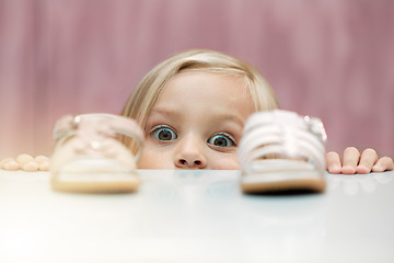 Image showing Girl, shoes and shopping with a child customer deciding between footwear for fashion, style or consumerism. Children, retail and option with a kid looking at a sandle and comparing for her wardrobe